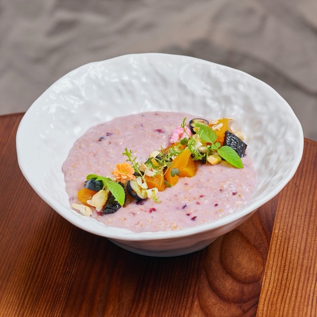Oatmeal on coconut milk with berries and dried fruits
